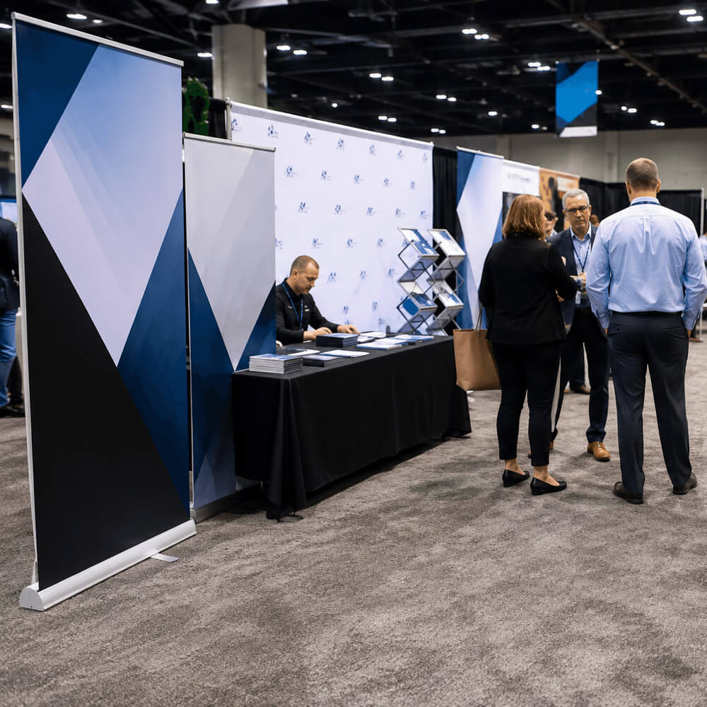 People at a trade show displaying trade show banners with booths and displays