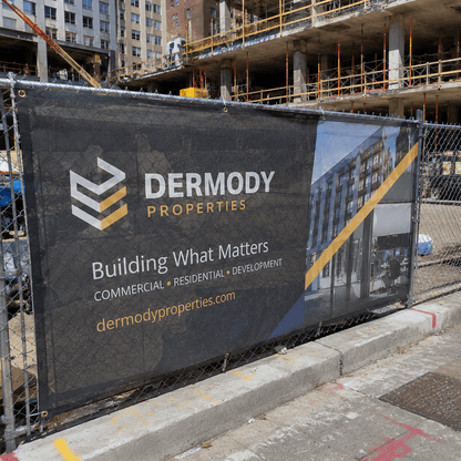 Construction site mesh banner attached to temporary fencing