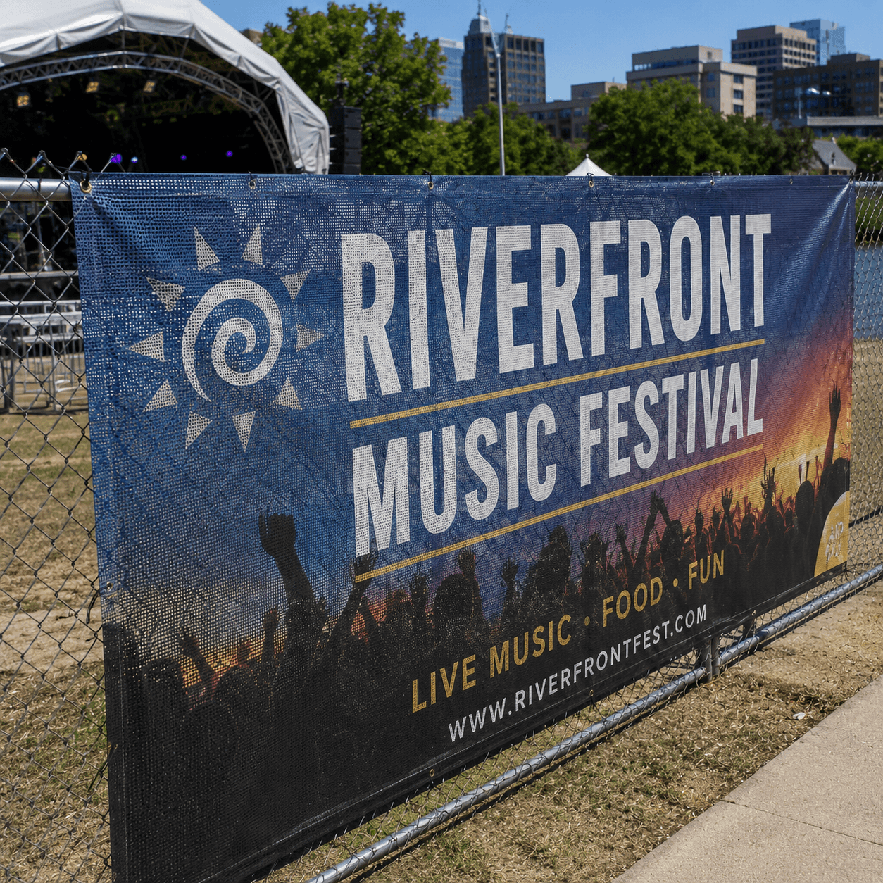 Outdoor festival mesh banner displayed on event perimeter fence